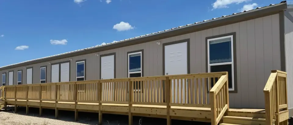 Exterior with deck of a 16×76 5-bed crew unit with shared kitchen