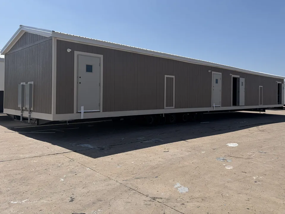 Crew housing unit with separate exterior entry doors and twin electrical panels, ready for delivery